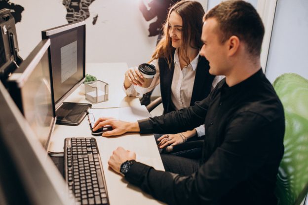 Video editing session for a corporate video production project in Mississauga, featuring two team members collaborating at a workstation.